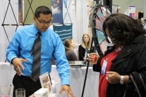 Healthy Futures Health Educator talking with APHA meeting attendee